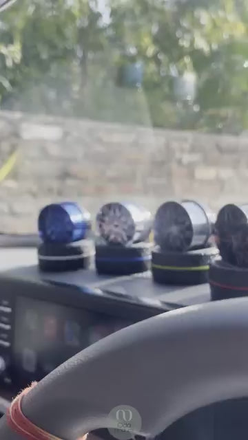 Close-up of solar-powered rotating car air freshener showcasing its sleek design.